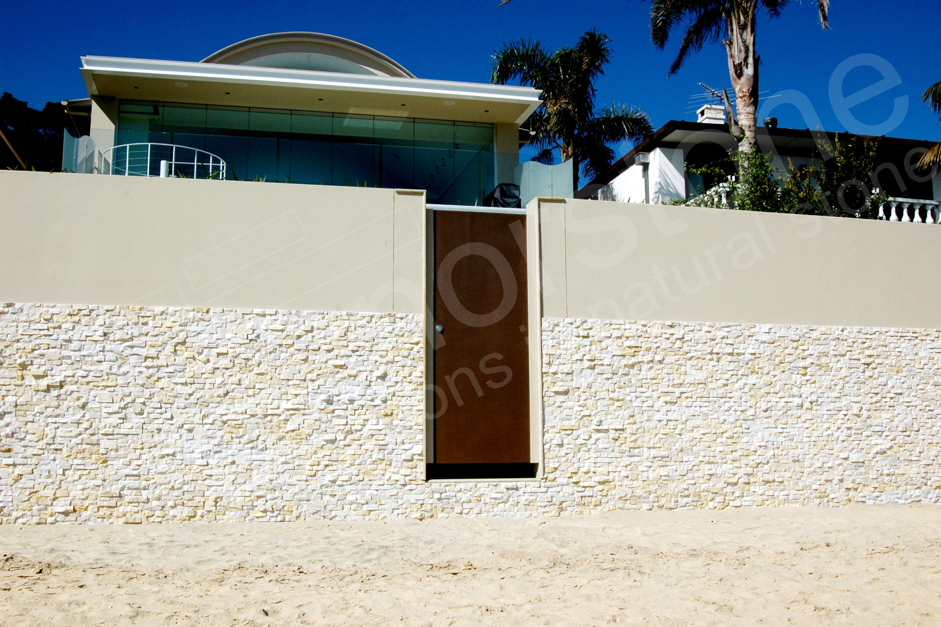 Norstone Ivory Rock Panels on a coastal sea wall with small beach near Sydney, Australia